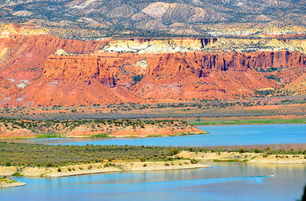 Abiquiu Reservoir New Mexico red sandstone canyon walls and blue water paddleboarding destination