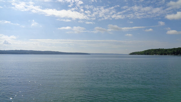 Torch Lake in Antrim County, Michigan, showing its clear turquoise glacial water, a popular paddleboarding destination