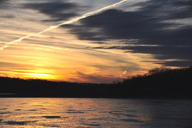 Clinton Lake Kansas at sunset, calm water reflecting golden light -- best Kansas paddleboarding location