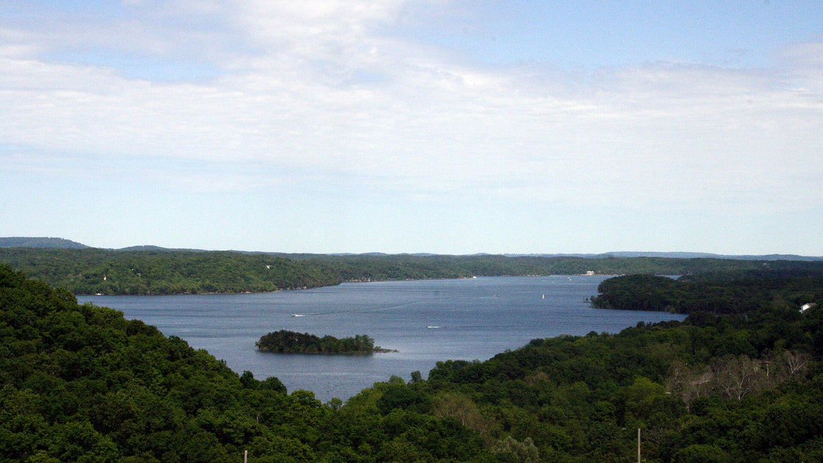 Beaver Lake in the Arkansas Ozarks, a clear blue reservoir with wooded islands, popular for paddleboarding