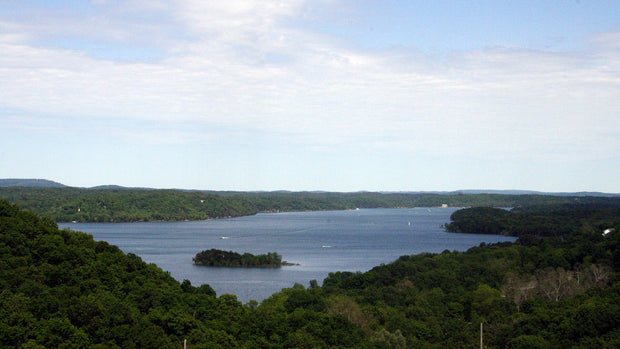 Beaver Lake in the Arkansas Ozarks, a clear blue reservoir with wooded islands, popular for paddleboarding