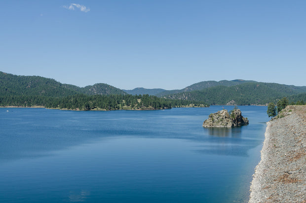 Pactola Reservoir in the Black Hills of South Dakota, viewed from Pactola Dam -- clear water surrounded by ponderosa pine forest, the best SUP spot in the state