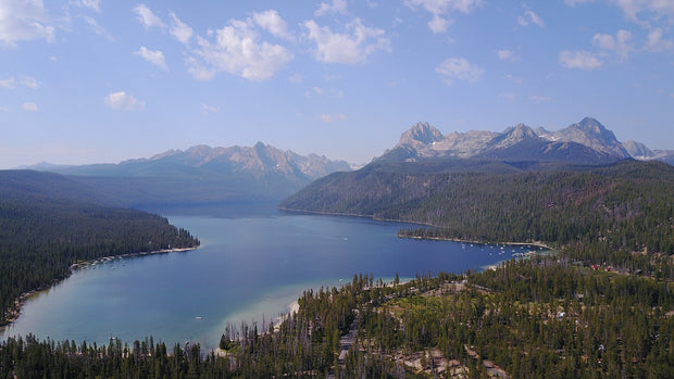 Redfish Lake with Sawtooth Mountains reflected in clear alpine water, Idaho paddleboarding