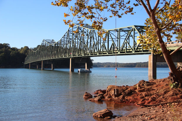Browns Bridge over the blue water of Lake Lanier, Georgia, the state's most popular paddleboarding lake, framed by autumn foliage