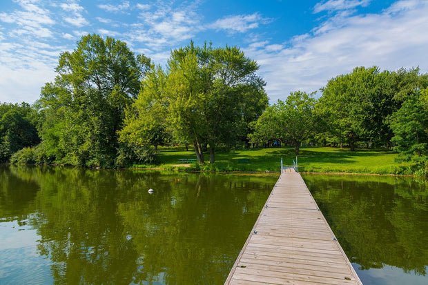 Summer paddling on a calm Iowa lake at a state park, a perfect paddleboard morning
