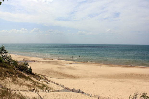 Indiana Dunes National Park beach on Lake Michigan, sandy shoreline with calm blue water and dunes